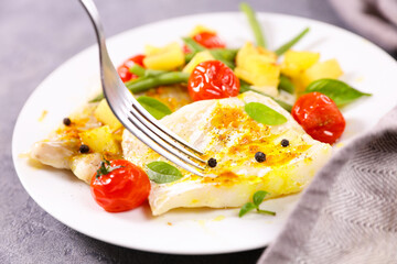 fish fillet with olive oil and vegetables