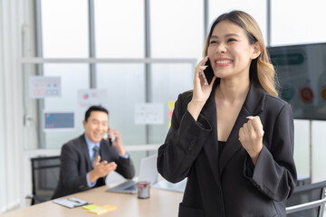 Asian businesswomen looking at the camera Working and meeting at the office at the company with colleagues at the back