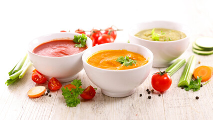 assorted of bowl of soup ( zucchini,  tomato and pumpkin or carrot)