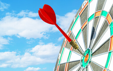 Close up shot red darts arrows in the target ,arrow hitting the center of a shooting target for...