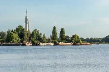 Fototapeten Recreational lake Mooie Nel in Spaarnwoude with a view on telecommunication tower © Milos