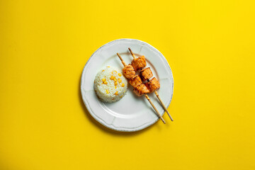 Rice with corn and salmon shish kebab