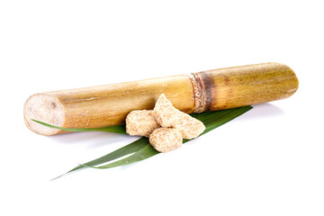 Sugar cane and brown sugar isolated on white background.