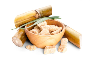 Brown sugar and sugar cane isolated on white background, closeup.