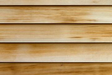 Horizontal rows of cedar wood siding as an exterior wall close view