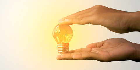 Glowing light bulb in human hand with creative concept of innovation thinking, inspiration success...