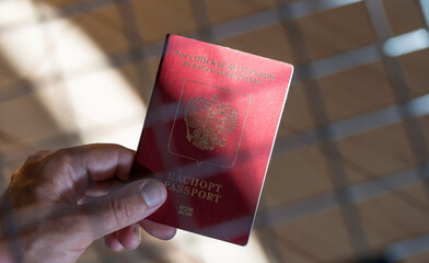 Russian passport in the hands of a man. Prohibition of Schengen visas for Russian tourists to...