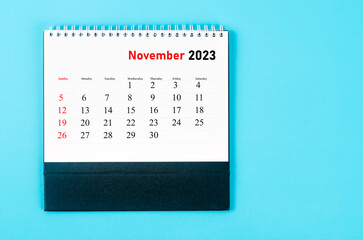 The November 2023 Monthly desk calendar for 2023 year on blue background.