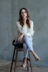 Happy friendly woman posing indoor at home in casual clothes. Lifestyle female portrait at home.