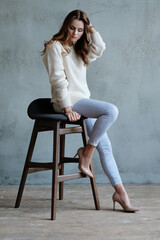 Happy friendly woman posing indoor at home in casual clothes. Lifestyle female portrait at home.