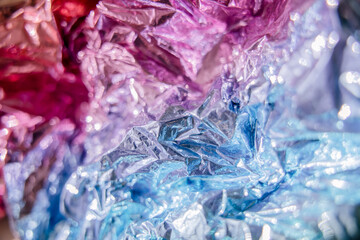 Fototapeta premium Iridescent foil texture background. Holographic wrinkled surface. Vibrant gradient template for design.