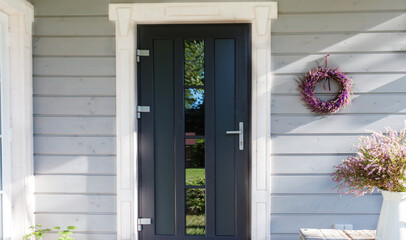 Autumn heather wreath decorating front door. Autumn fall concept