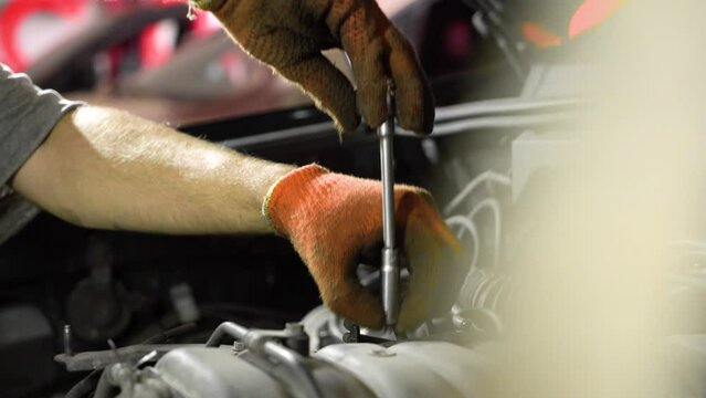 Auto mechanic repairs car engine. car service. close-up