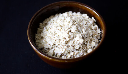 oatmeal in a brown bowl with dark background