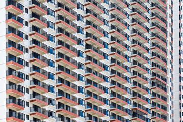 Close up of regular and neat balcony windows on a residential building in the city