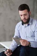 Young stressed handsome businessman working in office. 