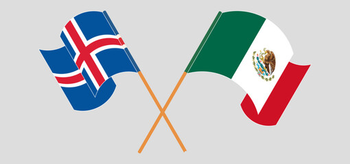 Crossed and waving flags of Iceland and Mexico