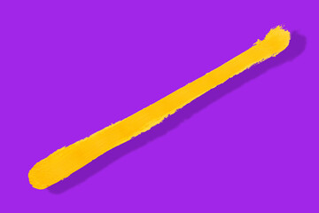 yellow brush and shadow isolated on a purple background