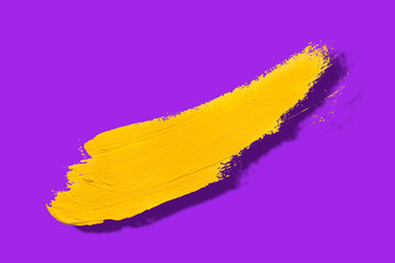 yellow brush and shadow isolated on a purple background