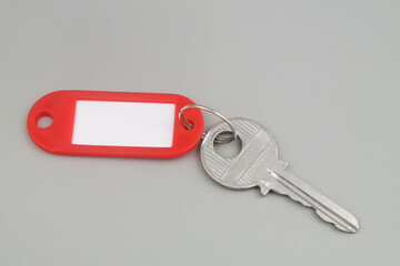 Key with label on gray background. Real estate business concept.