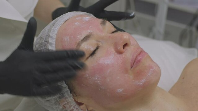 Facial skin care and health care. Close-up of a womans face in a beauty salon.