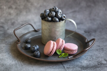 Pasta cake of different colors and with different flavors on a dark background.