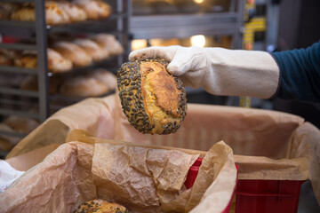Baker carrying a tray of freshly baked bread