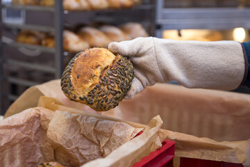 Baker carrying a tray of freshly baked bread