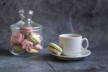 Pasta cake of different colors and with different flavors on a dark background.