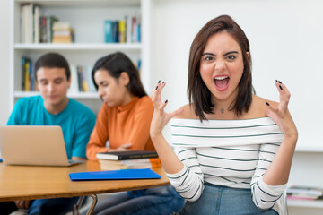 Angry german female student with group of computer science students