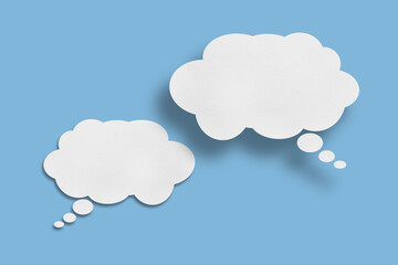 white cloud paper speech bubble shape against blue background