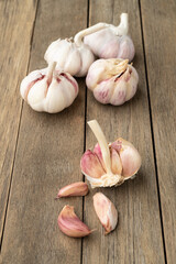 Garlic bulb and cloves over wooden table