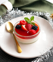 Italian panna cotta with red berries. Blackberries, strawberries and raspberries. Traditional Italian recipe.