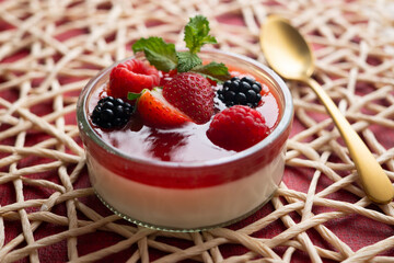 Italian panna cotta with red berries. Blackberries, strawberries and raspberries. Traditional Italian recipe.