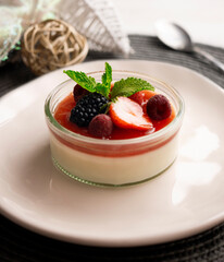 Italian panna cotta with red berries. Blackberries, strawberries and raspberries. Traditional Italian recipe.