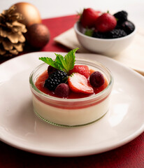 Italian panna cotta with red berries. Blackberries, strawberries and raspberries. Traditional Italian recipe.
