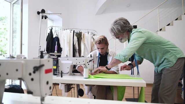 Team of fashion designers at work in a clothing design studio