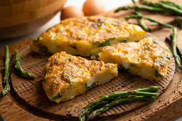 Spanish potato omelette with green asparagus. Traditional Spanish tapa recipe.