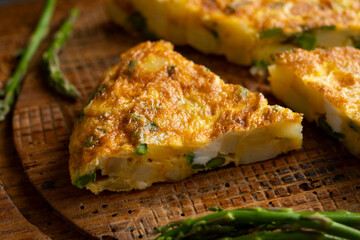 Spanish potato omelette with green asparagus. Traditional Spanish tapa recipe.