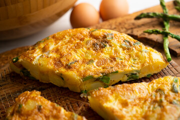 Spanish potato omelette with green asparagus. Traditional Spanish tapa recipe.