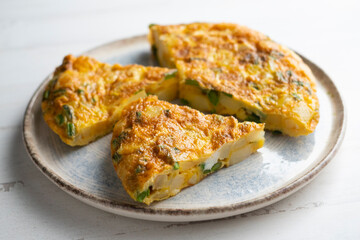 Spanish potato omelette with green asparagus. Traditional Spanish tapa recipe.