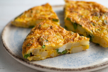 Spanish potato omelette with green asparagus. Traditional Spanish tapa recipe.
