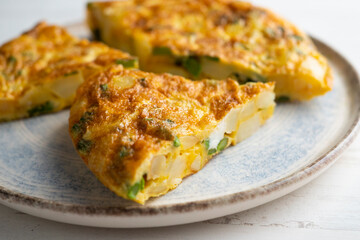Spanish potato omelette with green asparagus. Traditional Spanish tapa recipe.