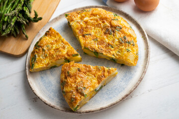 Spanish potato omelette with green asparagus. Traditional Spanish tapa recipe.