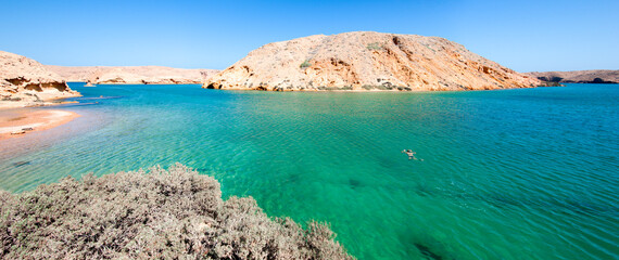 Woman swimming alone in Bandhar Khairan, Beach between Muscat and Seifa, Sultanate of Oman, Middle East, Arabian Peninsula - obrazy, fototapety, plakaty