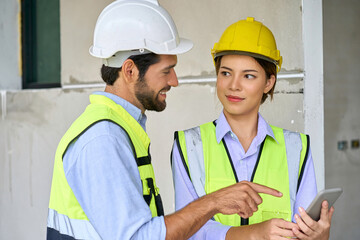 Two engineer foreman discussing with mobile phone on construction house site