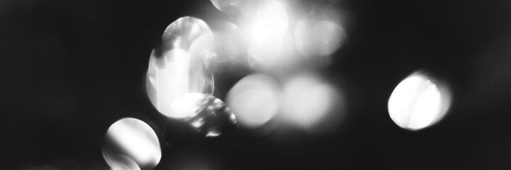 Blurred lights black and white background, banner texture. Abstract bokeh with soft light header. Wide screen wallpaper. Panoramic web banner with copy space for design