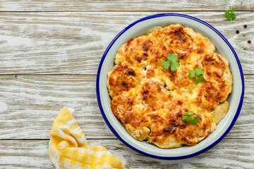 Rustic healthy meat vegetable loaded casserole on wooden background. Top view, copy space, flat lay.