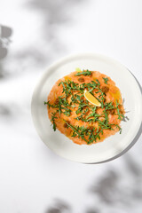 Salmon carpaccio with arugula on white background in summer day. Fish appetizer - salmon carpaccio...