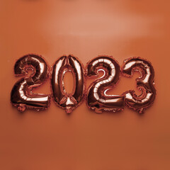 2023 Happy New Year concept from golden foil balloon